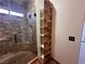 Bathroom with shower, built-in shelving, and stone tile at 422 Waterbrook Dr, Henderson, NV 89015