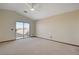 Spacious bedroom featuring a ceiling fan and sliding glass door leading to outdoor views at 422 Waterbrook Dr, Henderson, NV 89015