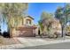 Two-story house with brown garage door and desert landscaping at 422 Waterbrook Dr, Henderson, NV 89015