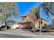 Two-story house with brown garage door and mature trees at 422 Waterbrook Dr, Henderson, NV 89015