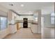 Well-lit kitchen with white cabinets, granite countertops, and tile flooring at 422 Waterbrook Dr, Henderson, NV 89015