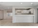 Kitchen with white cabinets, breakfast bar, and view from living room at 422 Waterbrook Dr, Henderson, NV 89015