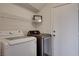 Bright laundry room features washer, dryer, and overhead shelving at 422 Waterbrook Dr, Henderson, NV 89015