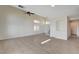 Neutral living room featuring tile floors, natural light, and a staircase at 422 Waterbrook Dr, Henderson, NV 89015