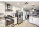 Modern kitchen with stainless steel appliances and white cabinets at 427 Shamrock Dr, Henderson, NV 89002