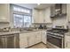 Bright kitchen with white cabinets, stainless steel appliances and tile backsplash at 427 Shamrock Dr, Henderson, NV 89002