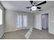 Well lit bedroom with ceiling fan and access to upper level at 4530 Lime Straight Dr, Las Vegas, NV 89115