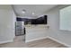 Modern kitchen with dark cabinets and stainless steel fridge at 4530 Lime Straight Dr, Las Vegas, NV 89115