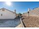 Gravel backyard with a partial view of the house and block wall at 5417 Lemhi Ct, North Las Vegas, NV 89031