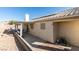 Covered patio with seating area, adjacent to a gravel backyard at 5417 Lemhi Ct, North Las Vegas, NV 89031