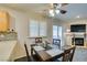 Bright dining area with table and chairs, adjacent to a living room with fireplace at 5417 Lemhi Ct, North Las Vegas, NV 89031