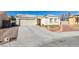 Front view of a house with a driveway, garage, and neatly kept landscaping at 5417 Lemhi Ct, North Las Vegas, NV 89031