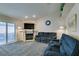 Spacious living room with a fireplace, sliding glass doors, and gray carpeting at 5417 Lemhi Ct, North Las Vegas, NV 89031