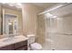 Bathroom featuring vanity with stone countertop, toilet and glass enclosed stone shower at 5490 Tulip Hill Ave, Las Vegas, NV 89141