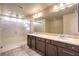 Bathroom with a large vanity, double sinks, and walk-in shower with glass door at 5490 Tulip Hill Ave, Las Vegas, NV 89141