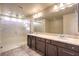 Double vanity bathroom with a large mirror and walk-in shower at 5490 Tulip Hill Ave, Las Vegas, NV 89141