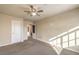 Spacious bedroom with ceiling fan and access to hallway at 5490 Tulip Hill Ave, Las Vegas, NV 89141