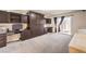 Bedroom with brown cabinets, carpet, desk and closet space, and sliding door to the backyard at 5490 Tulip Hill Ave, Las Vegas, NV 89141