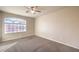 Bedroom with ceiling fan and arched window at 5490 Tulip Hill Ave, Las Vegas, NV 89141