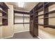 Walk-in closet with built-in shelving and drawers for optimal organization at 5490 Tulip Hill Ave, Las Vegas, NV 89141