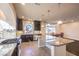 Well-lit kitchen boasts dark wood cabinetry, a granite island, and a breakfast nook nearby at 5490 Tulip Hill Ave, Las Vegas, NV 89141
