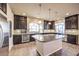Kitchen featuring stainless appliances, an island with a marble countertop and tile backsplash at 5490 Tulip Hill Ave, Las Vegas, NV 89141