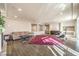 Bright, open-plan living room with hardwood floors, fireplace, recessed lights, exercise equipment, and a walkout at 5490 Tulip Hill Ave, Las Vegas, NV 89141