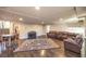 Expansive living room with wood floors, a grand rug, and comfortable leather sofas at 5490 Tulip Hill Ave, Las Vegas, NV 89141