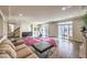 Bright, open-plan living room with hardwood floors, fireplace, recessed lights, exercise equipment, and a walkout at 5490 Tulip Hill Ave, Las Vegas, NV 89141