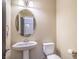 Charming powder room with pedestal sink and oval mirror at 5490 Tulip Hill Ave, Las Vegas, NV 89141