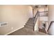 Carpeted staircase with decorative wrought iron railing leading to the upper level of the home at 5490 Tulip Hill Ave, Las Vegas, NV 89141