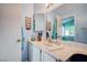 Bathroom featuring a vanity, sink, and a mirrored wall at 5767 Tabitha Ave, Las Vegas, NV 89156