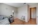 Bedroom featuring wood-look floors, natural light, and an adjacent doorway for easy access at 5767 Tabitha Ave, Las Vegas, NV 89156