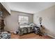 Bedroom with window letting in natural light, wood-look floors, and built-in shelves for storage at 5767 Tabitha Ave, Las Vegas, NV 89156