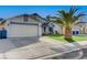 Single story home with synthetic grass, complemented by a palm tree and a clean two car driveway at 5767 Tabitha Ave, Las Vegas, NV 89156