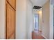 Hallway with wood-look floors connecting bedrooms; features wooden cabinet for convenient storage at 5767 Tabitha Ave, Las Vegas, NV 89156