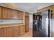 Functional kitchen with wood cabinets, laminate countertops, and a black refrigerator at 5767 Tabitha Ave, Las Vegas, NV 89156