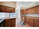 Kitchen featuring wood cabinets, laminate countertops, and an eat-in area at 5767 Tabitha Ave, Las Vegas, NV 89156