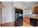 Functional kitchen with wood cabinets, black appliances, and laminate countertops at 5767 Tabitha Ave, Las Vegas, NV 89156