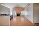 Open-concept living room features wood floors, a brick fireplace and large windows for natural light at 5767 Tabitha Ave, Las Vegas, NV 89156