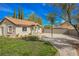 Single story home with terracotta roof and landscaped yard at 5840 N El Capitan Way, Las Vegas, NV 89149