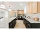 Modern kitchen with marble countertops and light wood cabinets at 5840 N El Capitan Way, Las Vegas, NV 89149