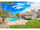 Backyard oasis featuring a sparkling pool and lush lawn at 5840 N El Capitan Way, Las Vegas, NV 89149