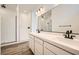 Modern bathroom with a double sink vanity, black fixtures, a walk-in shower, and wood-look tile flooring at 65 Ibiza Lake Dr, Henderson, NV 89011