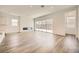 Bright living room featuring wood floors, recessed lighting, and sliding glass doors to the backyard at 65 Ibiza Lake Dr, Henderson, NV 89011