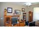 Relaxing living room with wood entertainment center and clock at 7566 Luna Del Rey St, Las Vegas, NV 89123