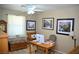 Home office with wood desk and comfortable seating at 7566 Luna Del Rey St, Las Vegas, NV 89123