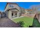 Exterior view of a house with a covered patio, green lawn, and block wall at 8040 Marshall Canyon Dr, Las Vegas, NV 89166