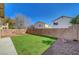 Backyard featuring a lush green lawn, decorative rock, and a sturdy perimeter wall at 8040 Marshall Canyon Dr, Las Vegas, NV 89166