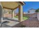 The covered patio leads to a yard landscaped with grass and decorative rock, enclosed with a block wall at 8040 Marshall Canyon Dr, Las Vegas, NV 89166